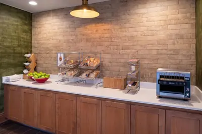 a kitchen with a counter with aasteryasteryasteryasteryasteryasteryasteryasteryastery at Fairfield Inn and Suites by Marriott Bakersfield Central in Bakersfield