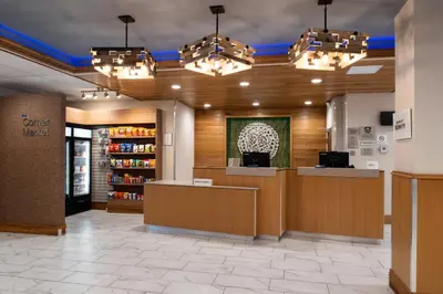 a lobby of a store with a counter and chandeliers at Fairfield Inn and Suites by Marriott Bakersfield Central in Bakersfield