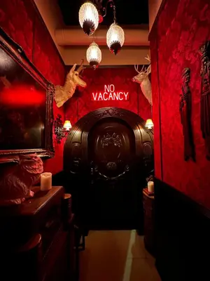 a red room with a no vacancy sign on the wall at The Rosemary in Los Angeles