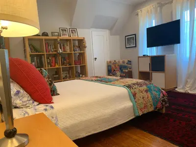 a bedroom with a bed and a book shelf at Beautiful airy architect-designed room and brand new private luxe bathroom in Los Angeles
