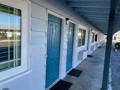 a row of doors on the side of a building at La Casa Motel, Garden Grove - Anaheim in Garden Grove