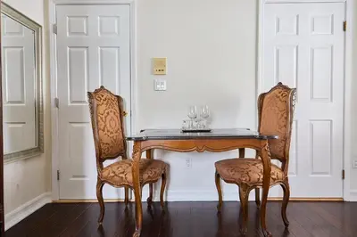 a table with two chairs and a table with glasses on it at Hollywood Hills Homestay in Los Angeles