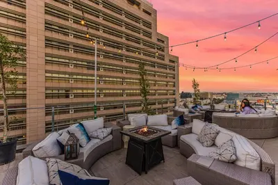 a rooftop patio with couches and a fire pit at One Lux Stay HWH Downtown Los Angeles in Los Angeles