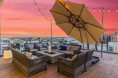 a patio with a fire pit and an umbrella at One Lux Stay HWH Downtown Los Angeles in Los Angeles