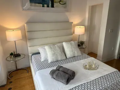 a bedroom with a bed with towels on it at One Lux Stay HWH Downtown Los Angeles in Los Angeles