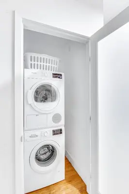 a white laundry room with a washer and dryer at One Lux Stay HWH Downtown Los Angeles in Los Angeles