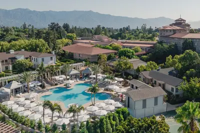 an aerial view of the resort with a pool and umbrellas at The Langham Huntington, Pasadena in Pasadena