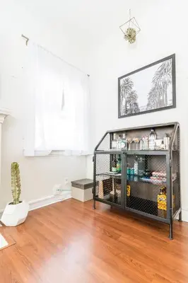a room with a shelf with items on it at Sunny Boho Chic West Hollywood Flat! in Los Angeles
