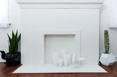 a white fireplace with white candles in a living room at Sunny Boho Chic West Hollywood Flat! in Los Angeles