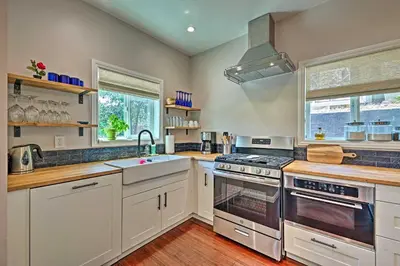 a kitchen with white cabinets and a stove top oven at Luxe Lake Arrowhead Farmhouse with Deck and Patio in Lake Arrowhead