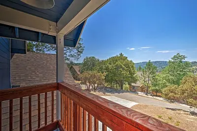 a view from the balcony of a house at Luxe Lake Arrowhead Farmhouse with Deck and Patio in Lake Arrowhead