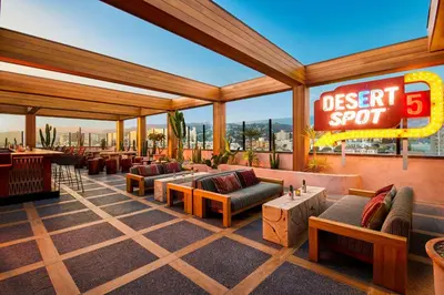a restaurant with a desert spot with couches and tables at HOLLYWOOD VOLUME, a Tribute Portfolio Hotel in Los Angeles