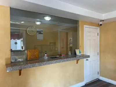a reflection of a restaurant counter in a mirror at Legacy inn & suites in Anaheim
