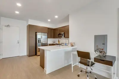 a kitchen with a white counter and a desk and a chair at Apart Hotel near Dodgers Stadium in Los Angeles