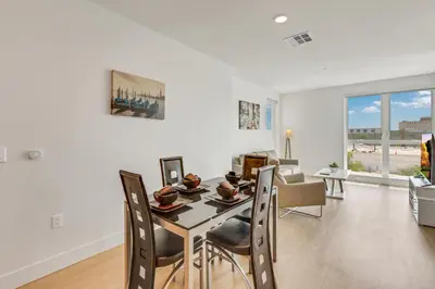 a dining room and living room with a table and chairs at Apart Hotel near Dodgers Stadium in Los Angeles