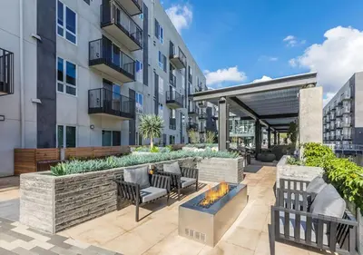 a patio with furniture and a fire pit in front of a building at Apart Hotel near Dodgers Stadium in Los Angeles