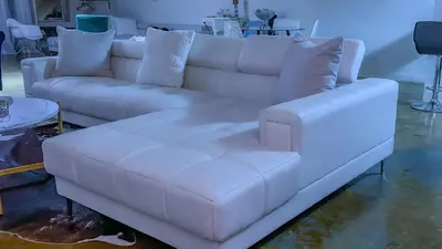 a white couch sitting in a living room at Huge Downtown LA Loft with Rooftop Pool & Jacuzzi in Los Angeles