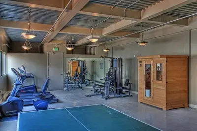 a gym with several tread machines and a ping pong ball at Huge Downtown LA Loft with Rooftop Pool & Jacuzzi in Los Angeles