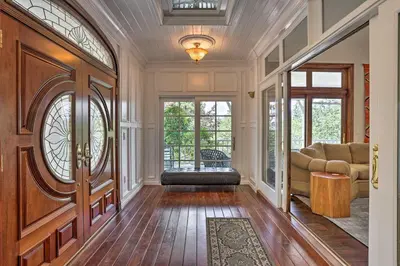 a hallway with a living room with a couch at Ornate Lake Arrowhead Home with Deck in Lake Arrowhead