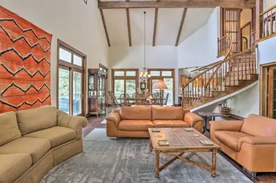 a living room with two couches and a table at Ornate Lake Arrowhead Home with Deck in Lake Arrowhead