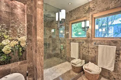 a bathroom with a shower and a toilet at Bakersfield Oasis Sweet Tropical Pool Setup! in Bakersfield