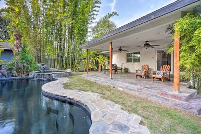 a house with a swimming pool in the backyard at Bakersfield Oasis Sweet Tropical Pool Setup! in Bakersfield
