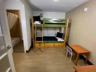 a small room with bunk beds and a table at Stanford Inn & Suites Anaheim in Anaheim