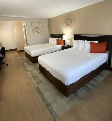 a hotel room with two beds in a room at Stanford Inn & Suites Anaheim in Anaheim