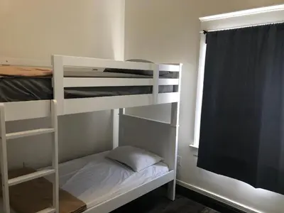 a bedroom with two bunk beds and a window at The Wilshire Metro in Los Angeles