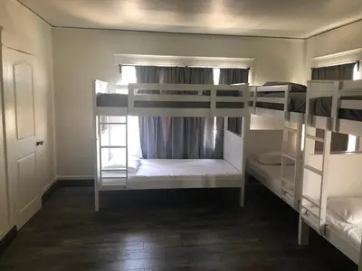 a room with three bunk beds with a window at The Wilshire Metro in Los Angeles