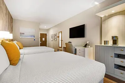 a hotel room with two beds and a flat screen tv at Cambria Hotel Calabasas - Malibu in Calabasas