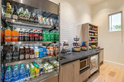 a refrigerator filled with lots of bottles of soda at Cambria Hotel Calabasas - Malibu in Calabasas
