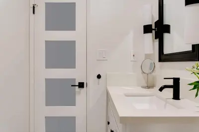 a white bathroom with a sink and a mirror at Sophisticated Long Beach Suite with Patio Dining and Parking NRP21-00185 in Long Beach