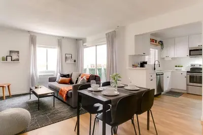 a living room with a couch and a table with chairs at Sophisticated Long Beach Suite with Patio Dining and Parking NRP21-00185 in Long Beach