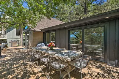 a table and chairs sitting on a patio at Airy Alpine Getaway with Lake Arrowhead Views! in Lake Arrowhead