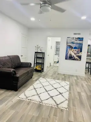 a living room with a couch and a rug at Blanquitas Home in Long Beach