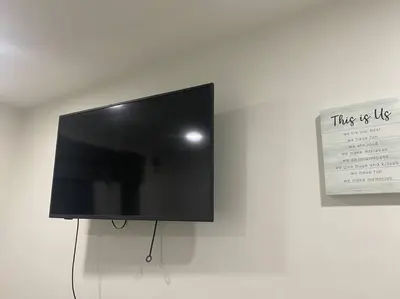 a flat screen tv hanging on a wall at Blanquitas Home in Long Beach