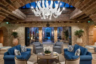 a living room with blue couches and a chandelier at Westlake Village Inn in Westlake Village