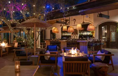 a restaurant with tables and chairs and a bar at Westlake Village Inn in Westlake Village