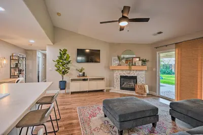 a living room with a ceiling fan and a fireplace at Family-Friendly Home, 6 Mi to Riverwalk Plaza in Bakersfield