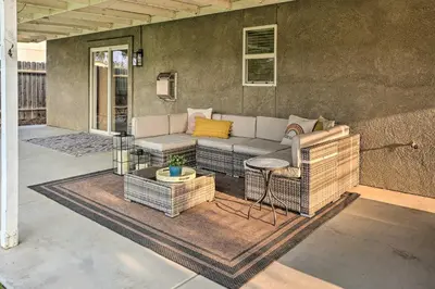 a patio with a couch and a table at Family-Friendly Home, 6 Mi to Riverwalk Plaza in Bakersfield