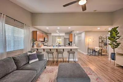 a living room with a couch and a kitchen at Family-Friendly Home, 6 Mi to Riverwalk Plaza in Bakersfield