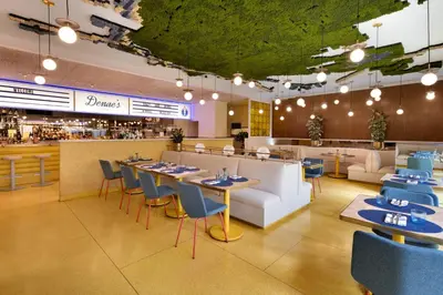 a restaurant with tables and chairs and a bar at The Delphi Downtown LA in Los Angeles