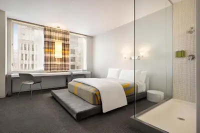 a hotel room with a bed and a desk and a tub at The Delphi Downtown LA in Los Angeles