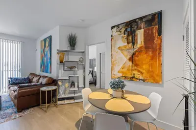 a living room with a table and a couch at 1 Luxury Apartment in Los Angeles