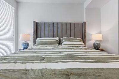 a bedroom with a large bed with two lamps at 1 Luxury Apartment in Los Angeles
