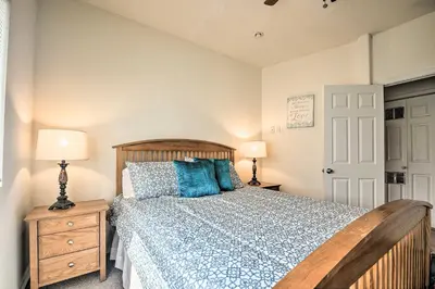 a bedroom with a wooden bed with blue pillows at 5 Mi to Universal Studios Family Gem with Hot Tub! in Burbank