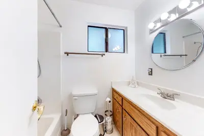 a bathroom with a sink and a toilet and a mirror at Morrison Manor in Lake Arrowhead