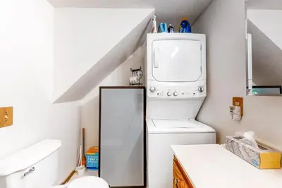 a bathroom with a toilet and a washer and dryer at Morrison Manor in Lake Arrowhead