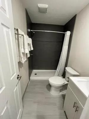 a bathroom with a white toilet and a shower at Fontana Inn in Fontana